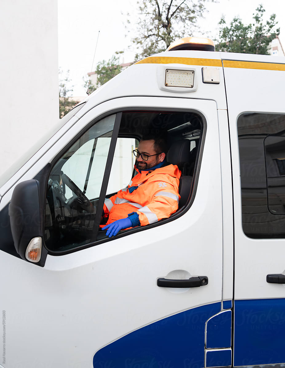 Smiling paramedic driving an ambulance