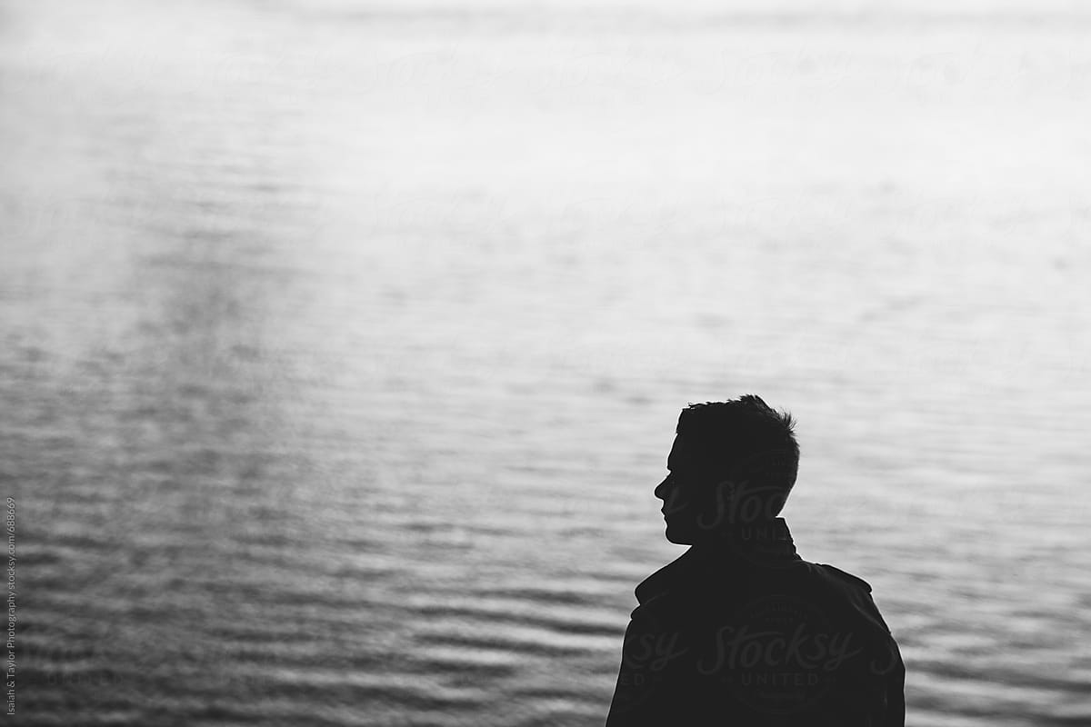 Mysterious silhouette of young man with water