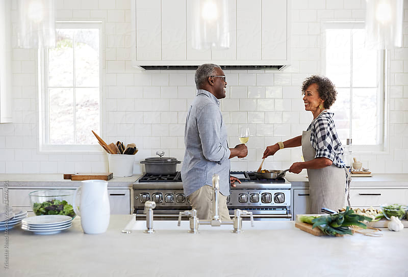 Senior African American couple cooking a meal together in the kitchen