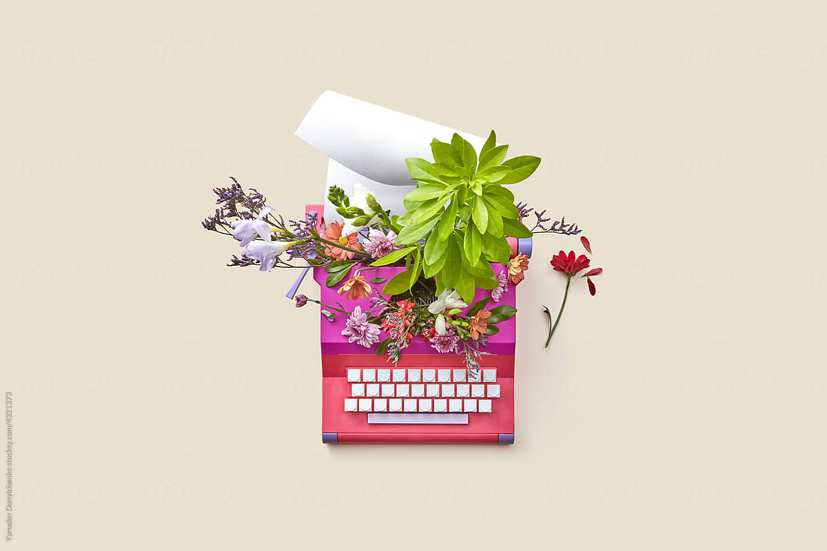 Vintage typewriter with flowers and paper