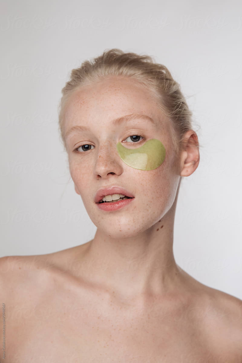 Young freckled model with green under eyepatches