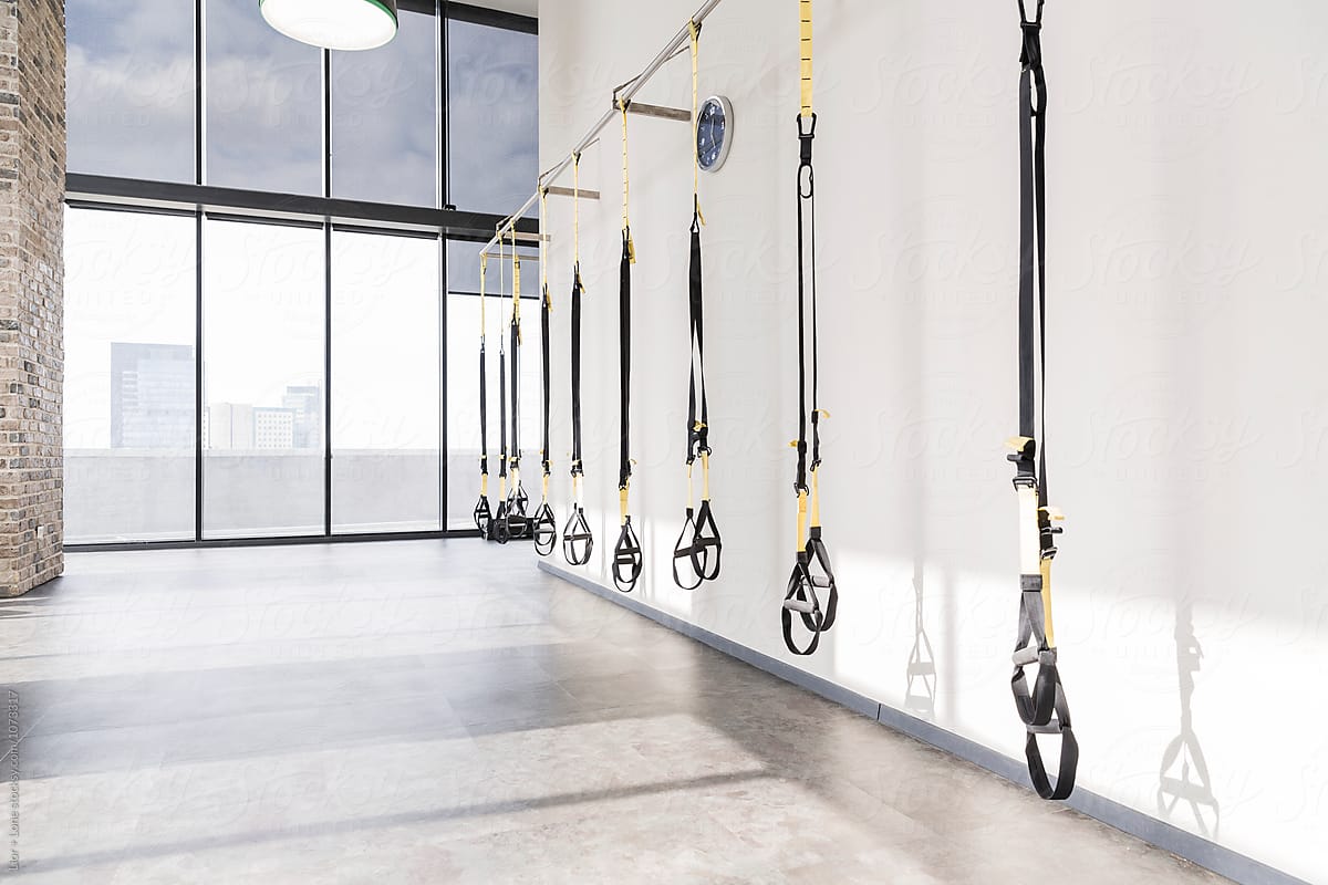 Empty modern workout studio with body weight straps