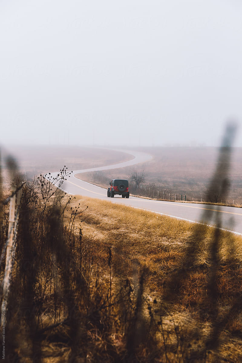 A Lone Jeep On A Foggy Road