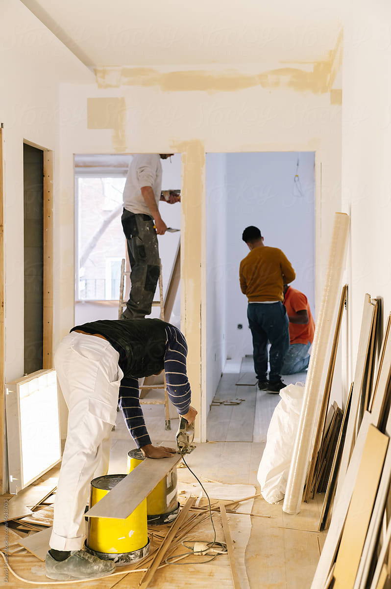 Team of workers renovating apartment