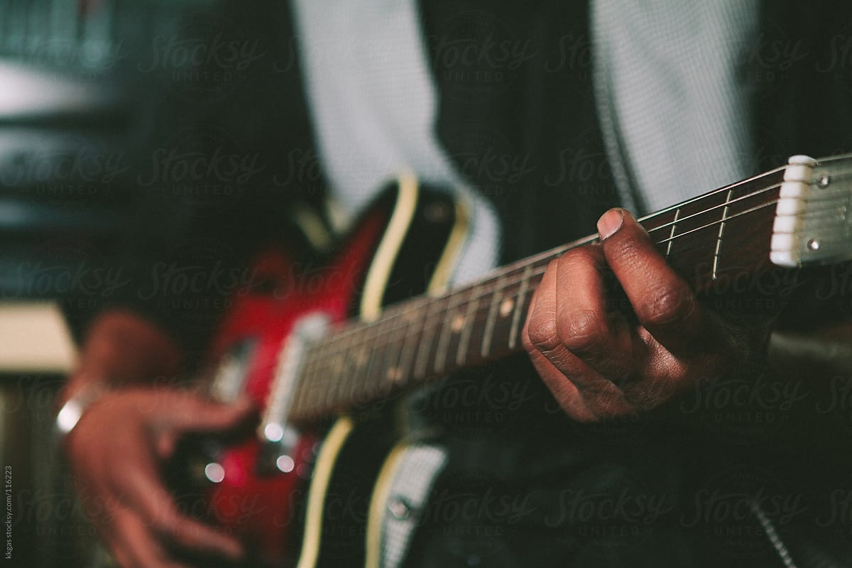 Musicians hands playing a guitar