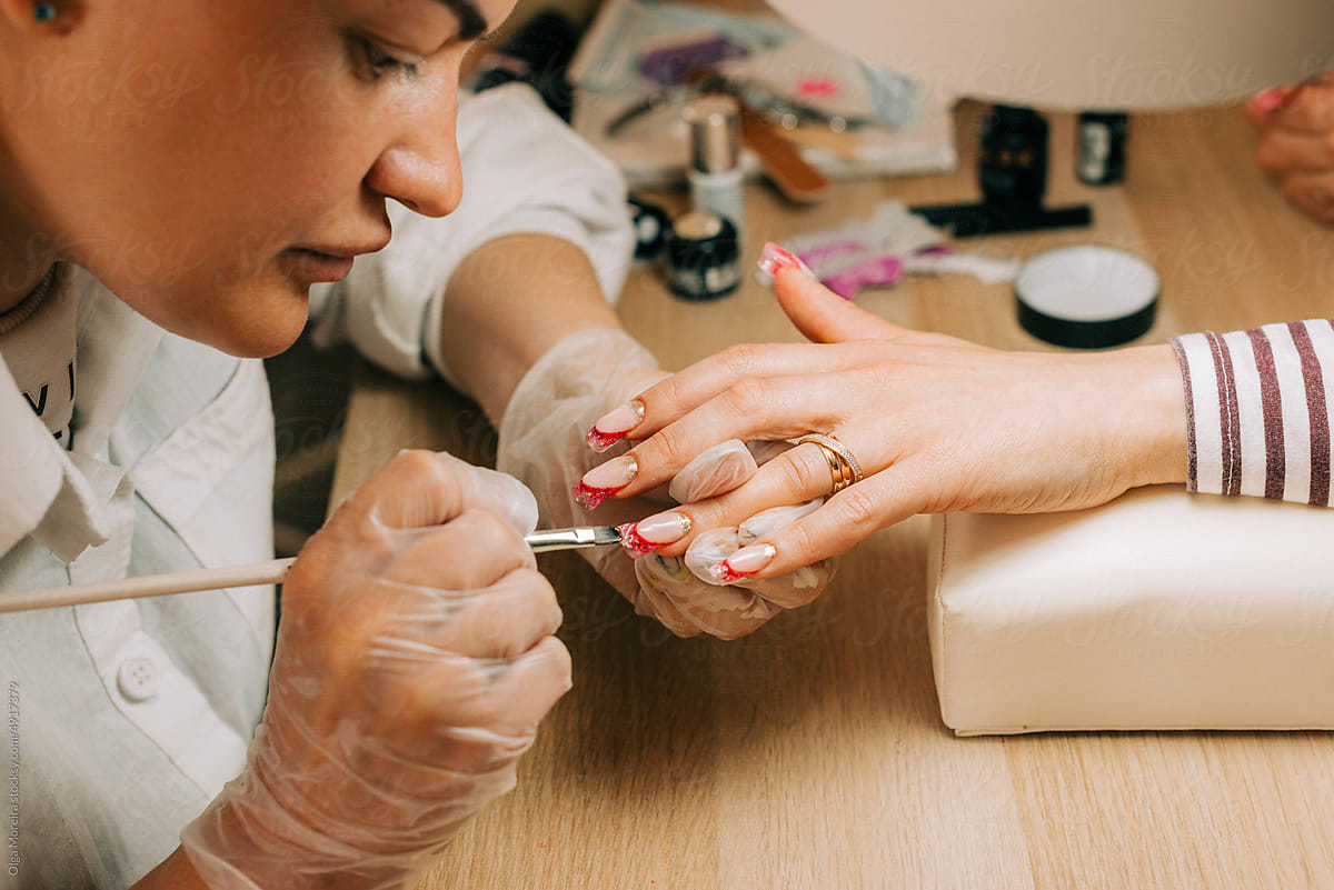 Female nail artist doing nail design