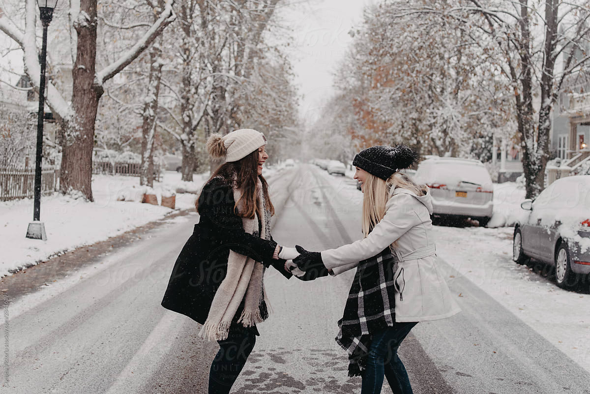 Two best friends walking around the city on a snowy day