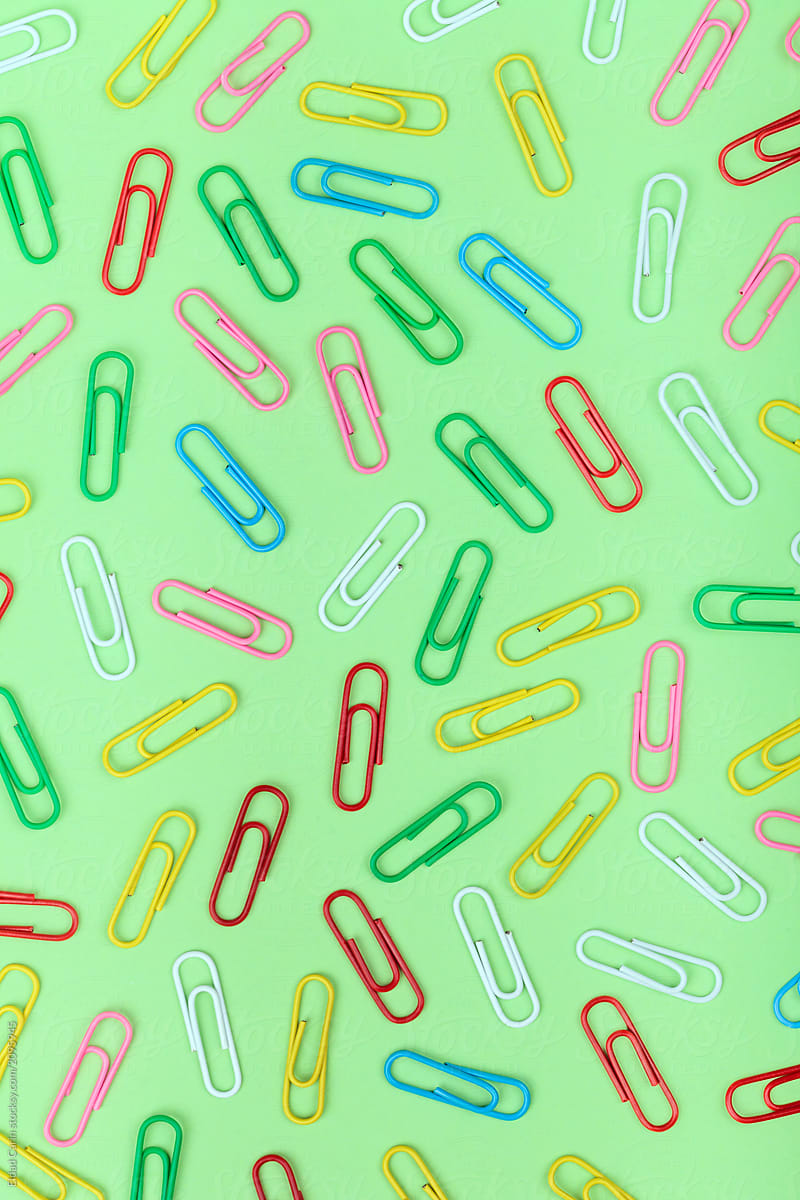 Colorful Paper Clips on Green
