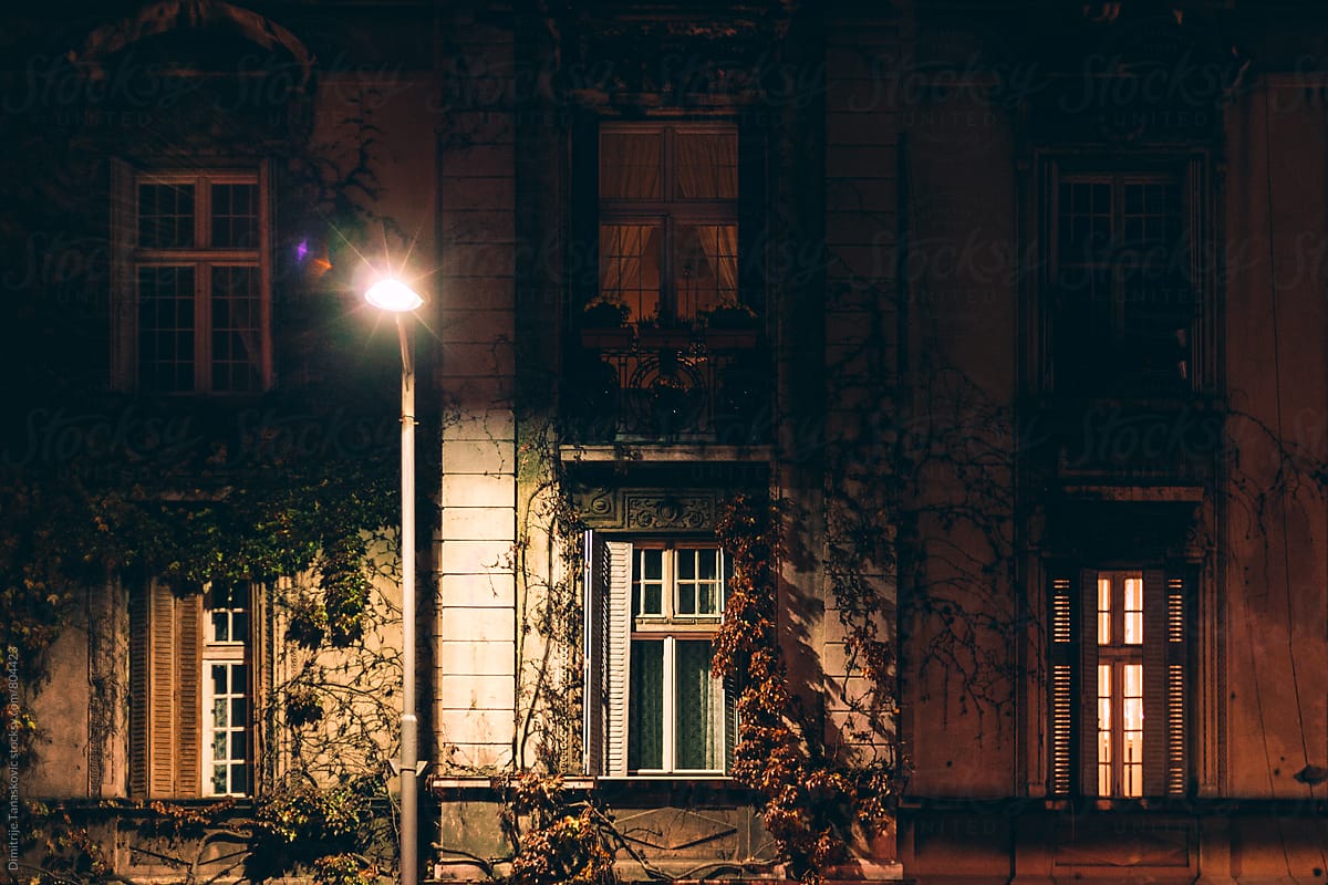 Facade of the old house lit by the street lighting