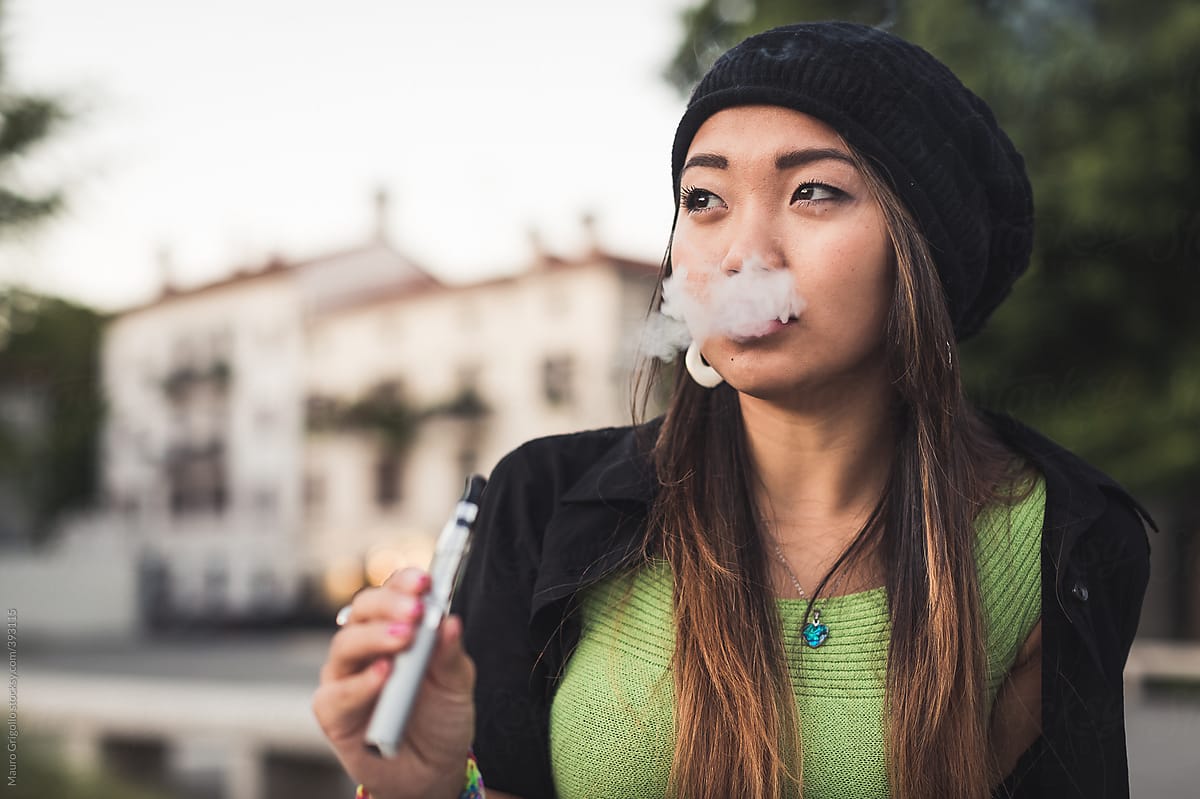 Asian Woman Smoking With E Cigarette By Stocksy Contributor Mauro Grigollo Stocksy