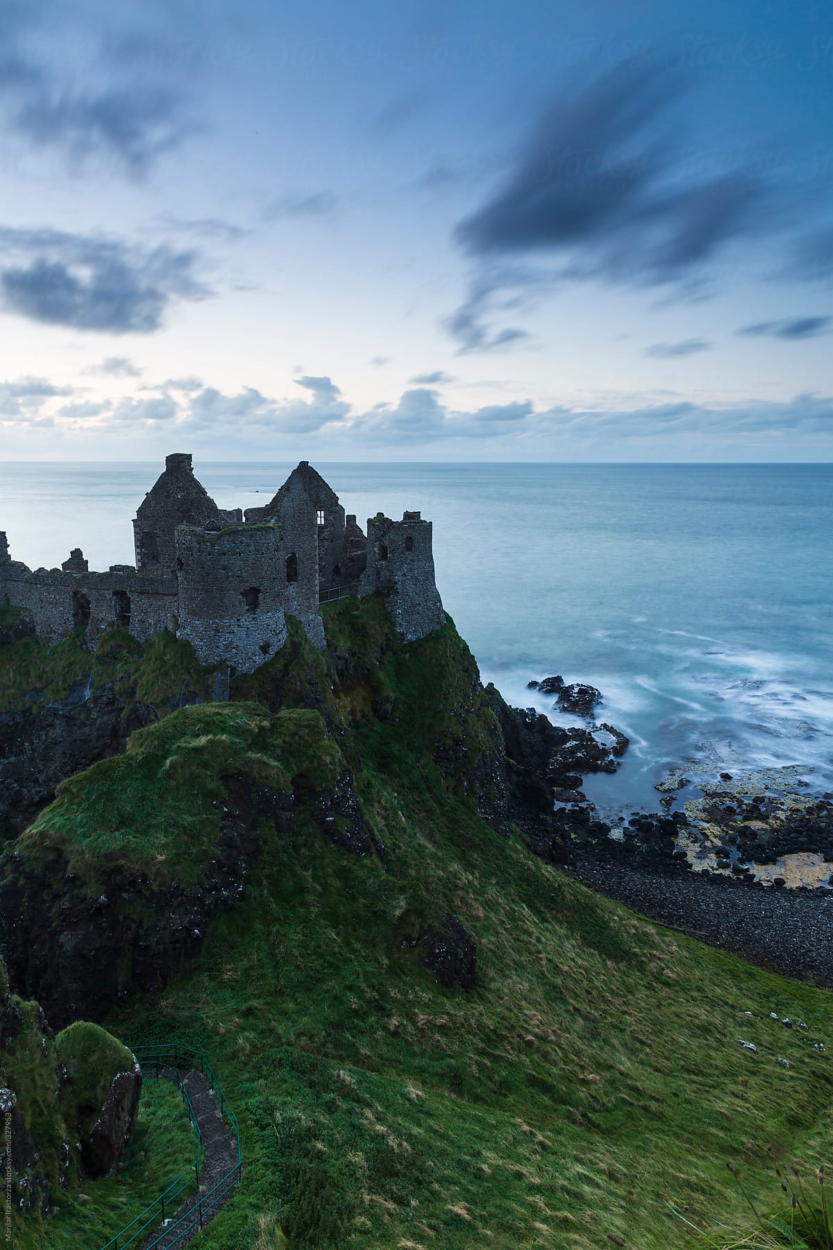 Ruins of a castle in the north Irish coast at sunset