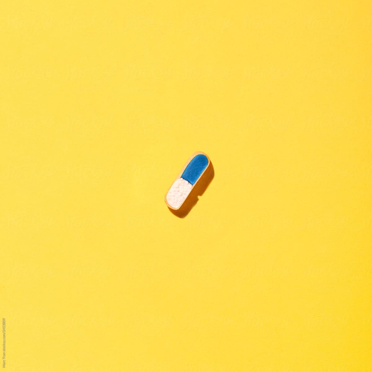 Pills on yellow background.