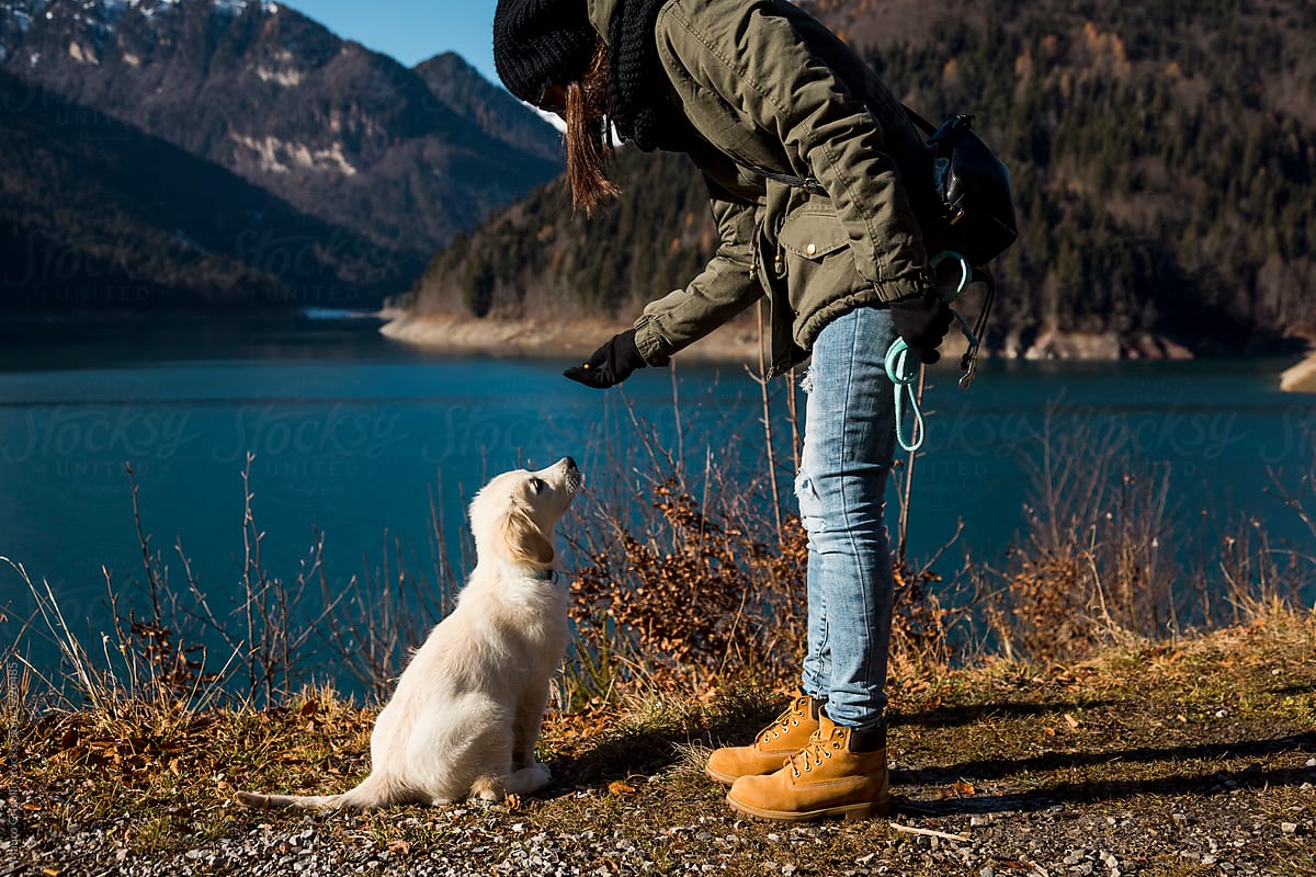 Girl with her dog at the lake