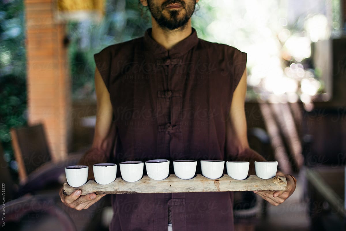 A man in the cafe with organic coffee tray