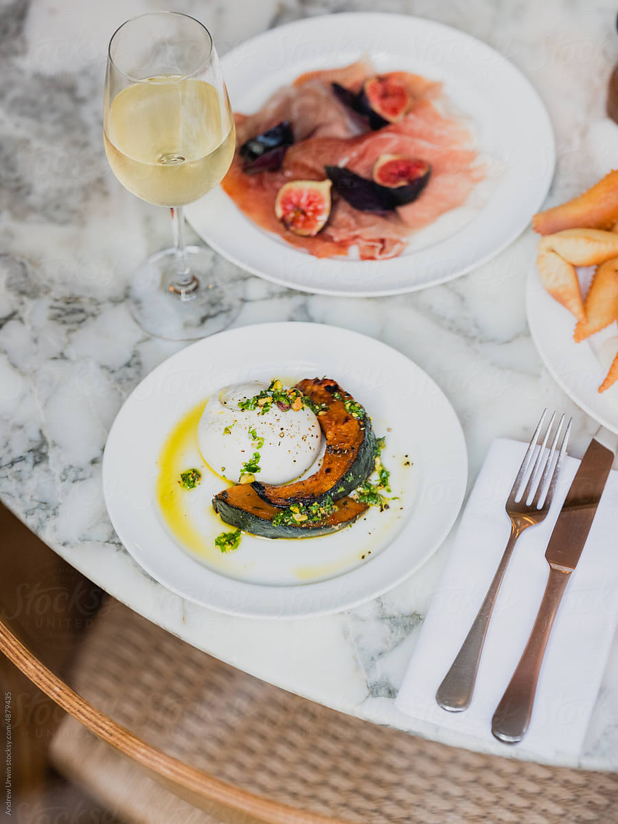 Burrata with roasted pumpkin and prosciutto with figs and parmesan
