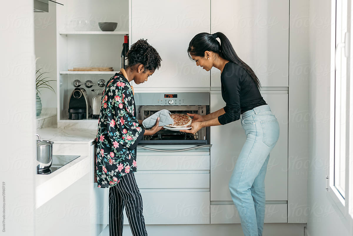 Black woman and teen girl cooking together