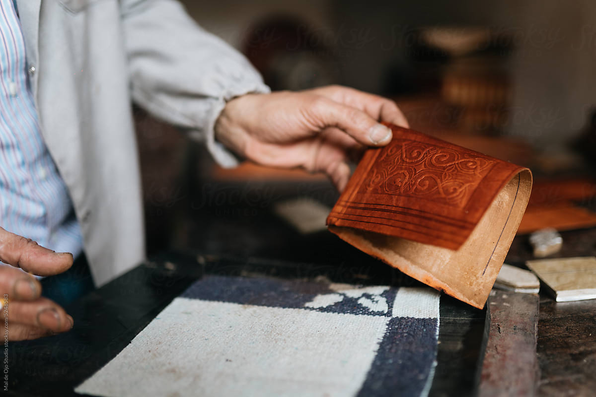 Artisan holding stamped leather