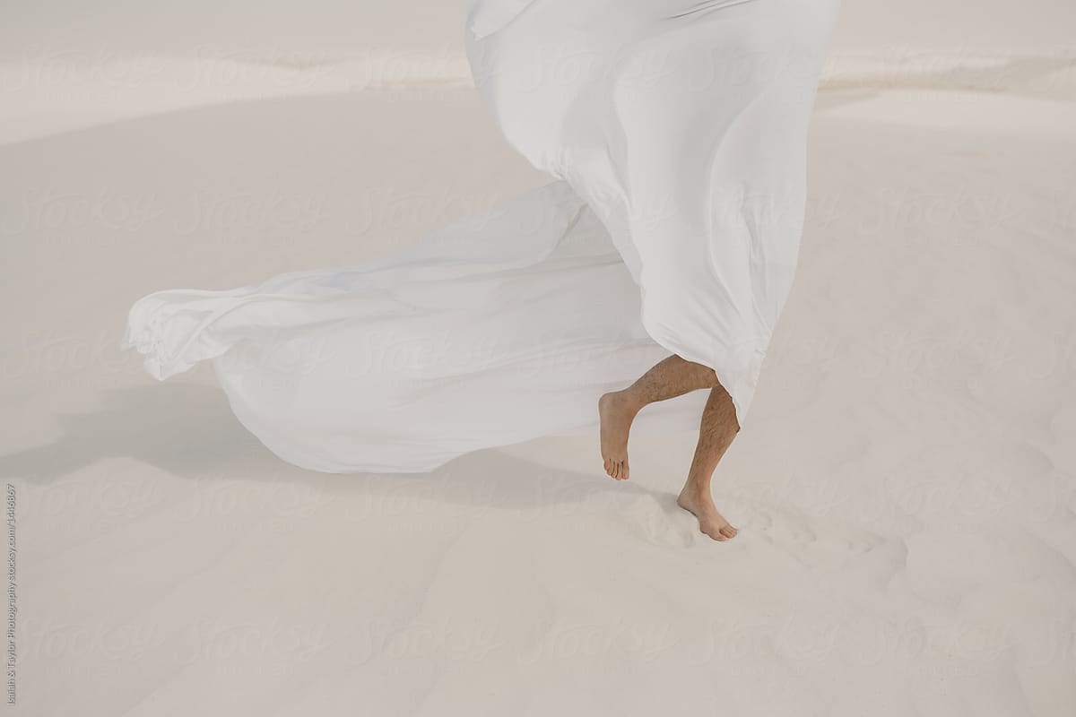 Feet walking on desert sand detail