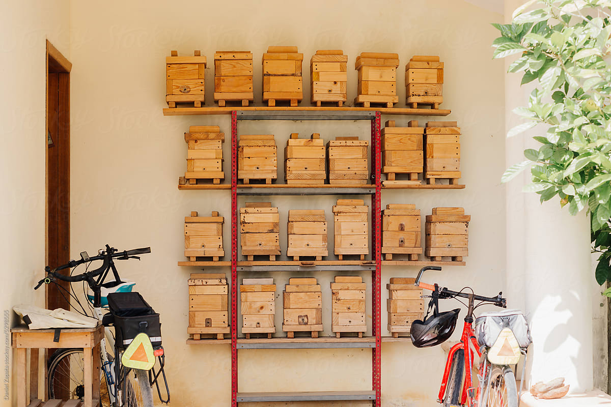 Furniture with bee hives, bicycles next to it