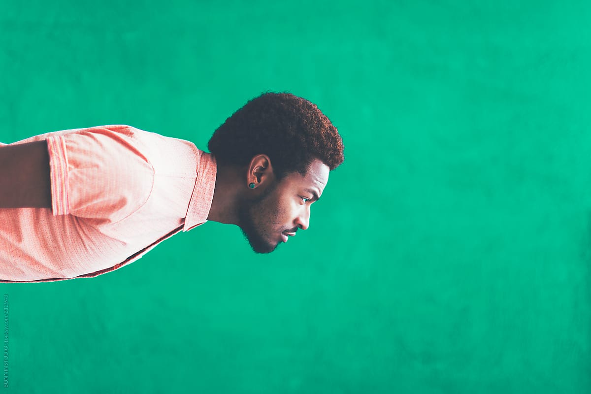 Sideway Portrait Of Modern Young Hipster Black Man In Front A Green