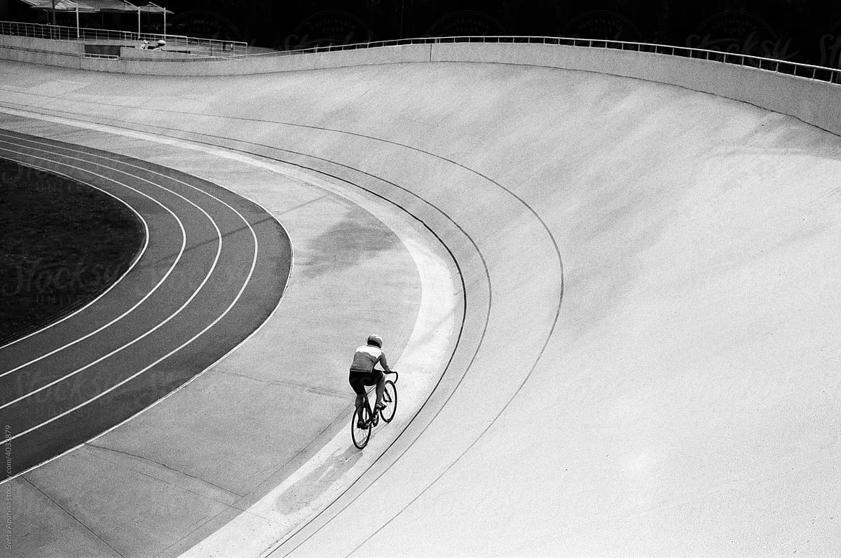 A track cycling biking fast on the track