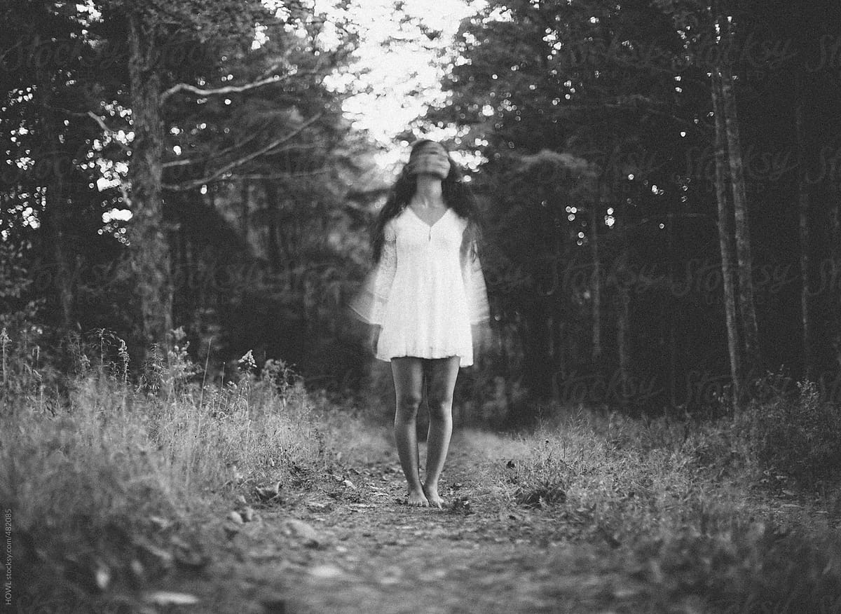 Lone Woman Stands Alone In Forest, Blurry Abstract Face | Stocksy United