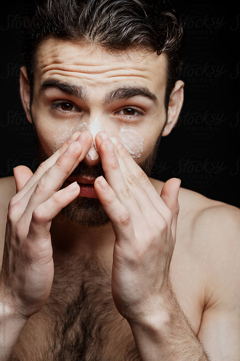 Closeup man exfoliating nose
