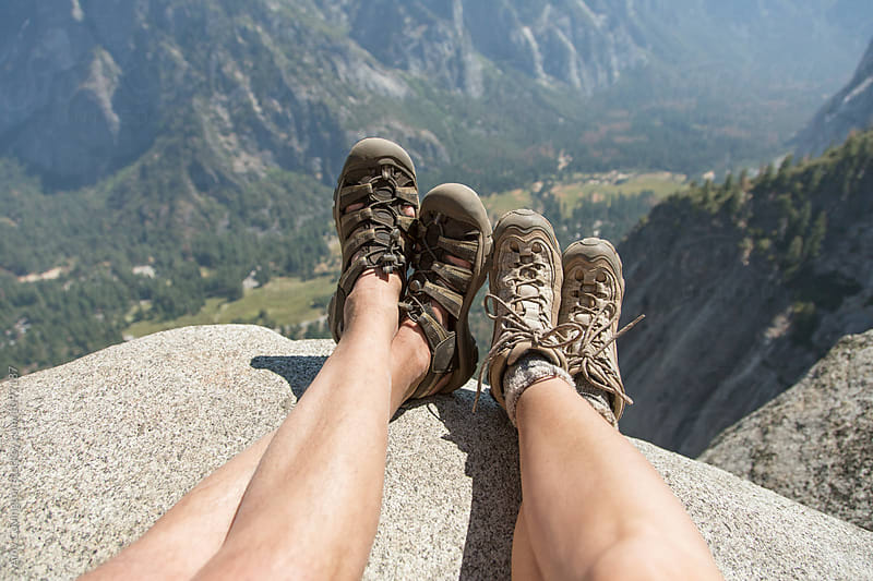 Legs of a couple enjoying the view after a long hike