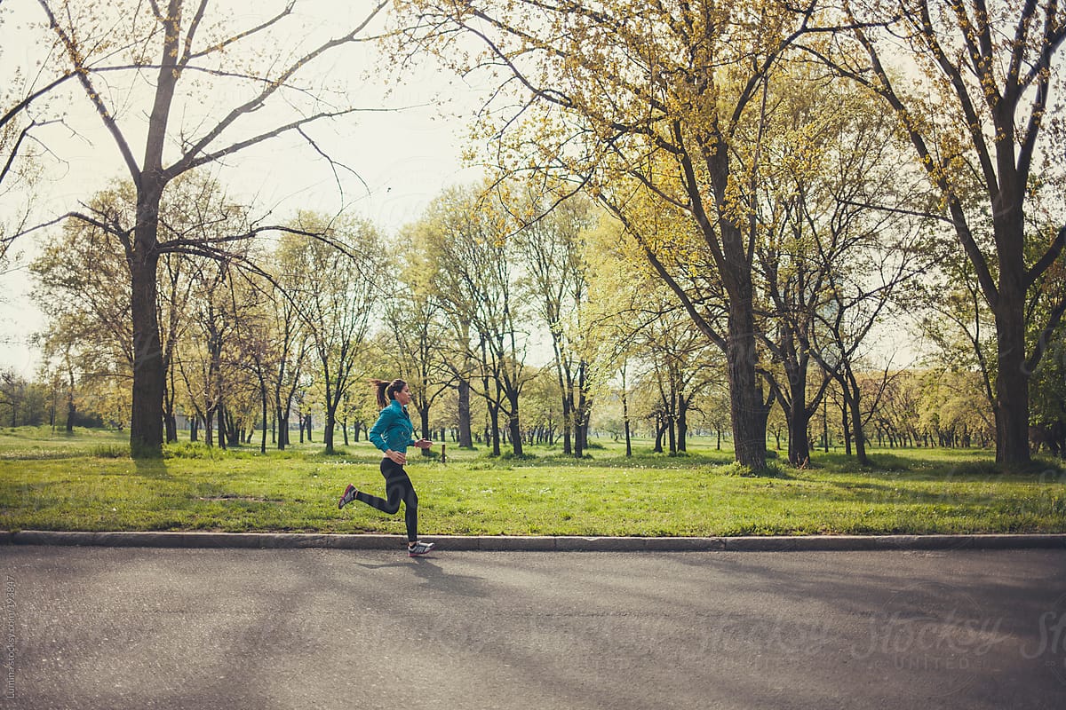 Woman Running In The Park By Stocksy Contributor Lumina Stocksy