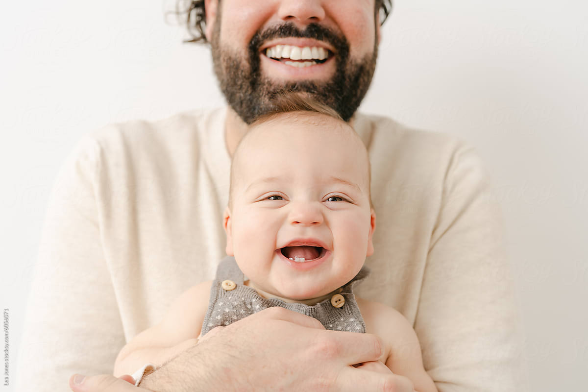 portrait of  happy father  with smiling baby in studio
