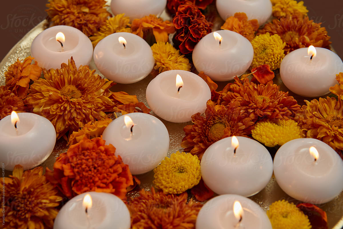 Closeup of white candles and flowers