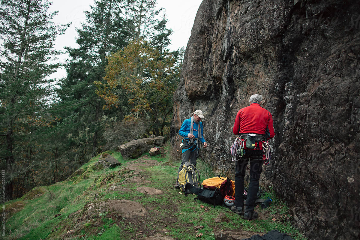 Two older friends enjoying nature and rock climbing together.