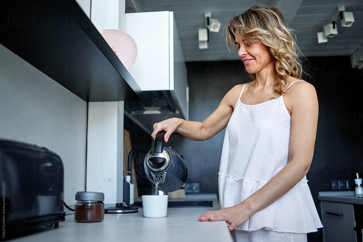 Woman making coffee in morning
