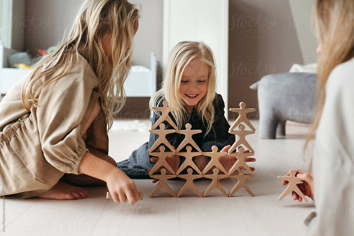 Children play with a wooden construction set together
