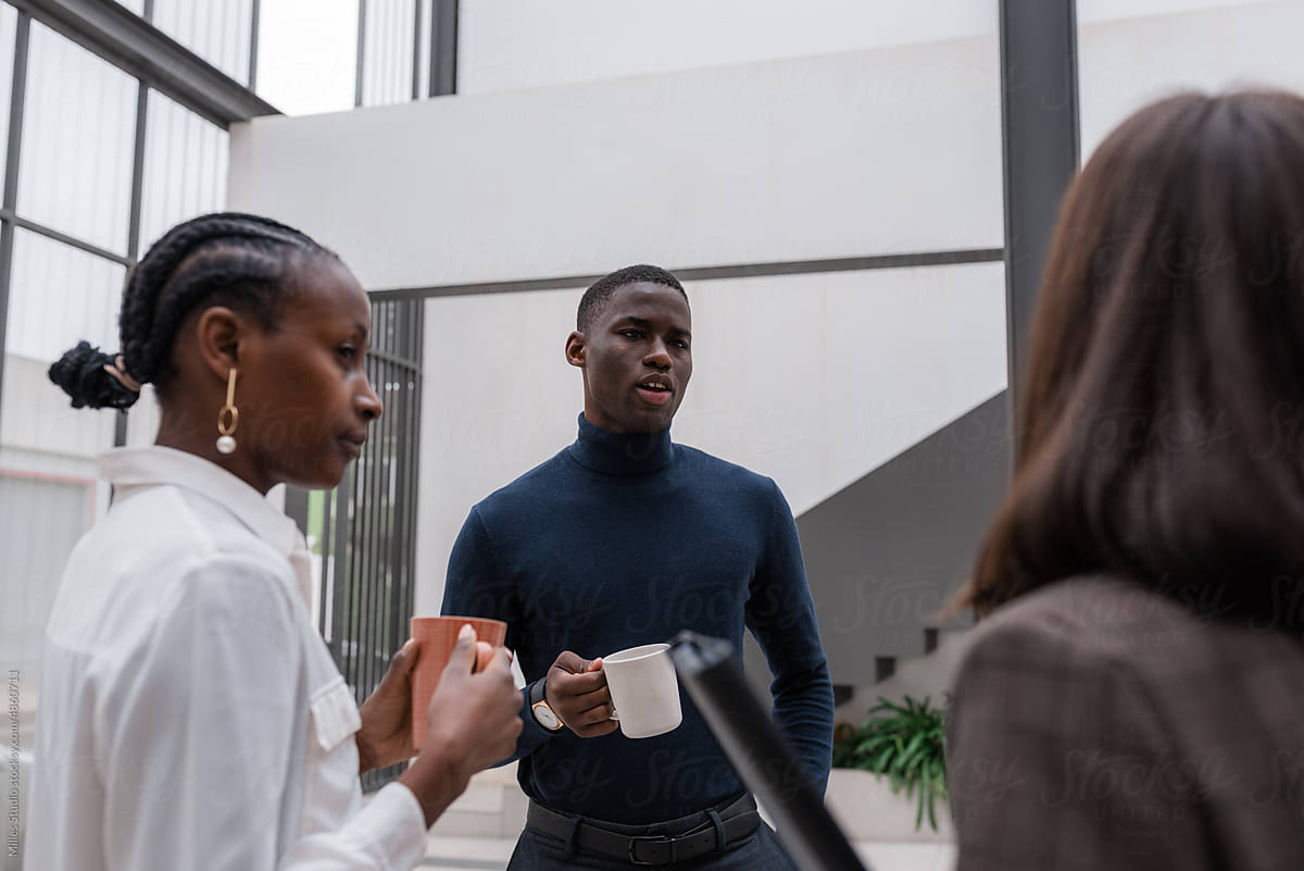 Black manager speaking with coworker during break