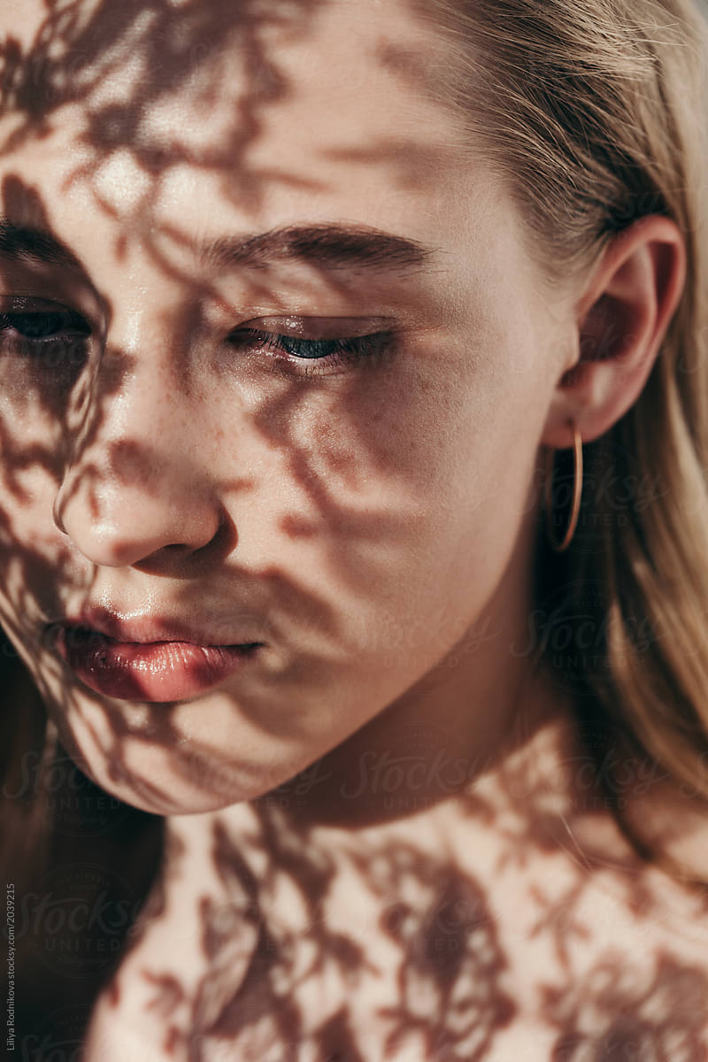 Closeup Portrait Of Amazing Girl With Floral Shadows On Her Face Del Colaborador De Stocksy 7966