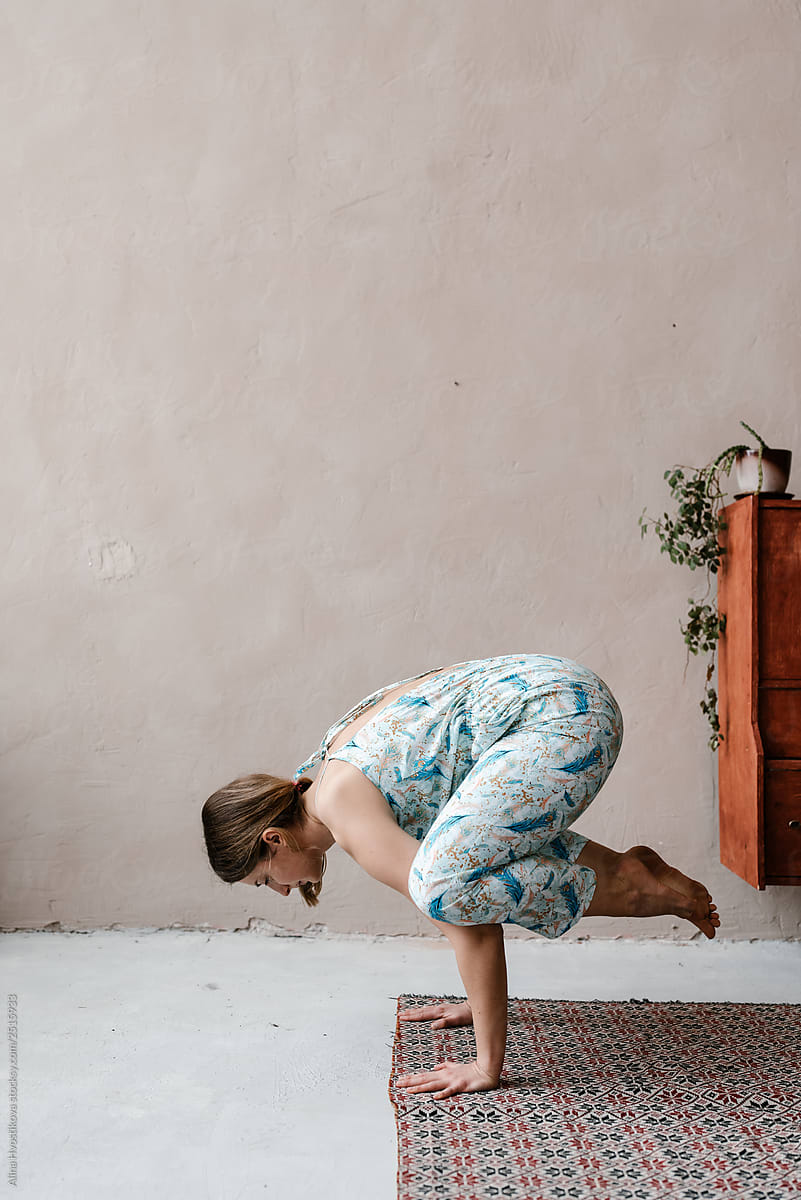 Young lady doing yoga exercise at home
