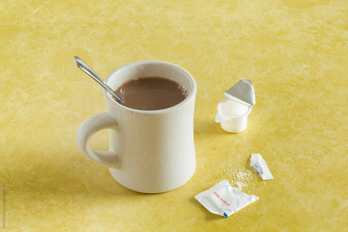 Retro coffee mug, spoon, sugar packet on diner counter