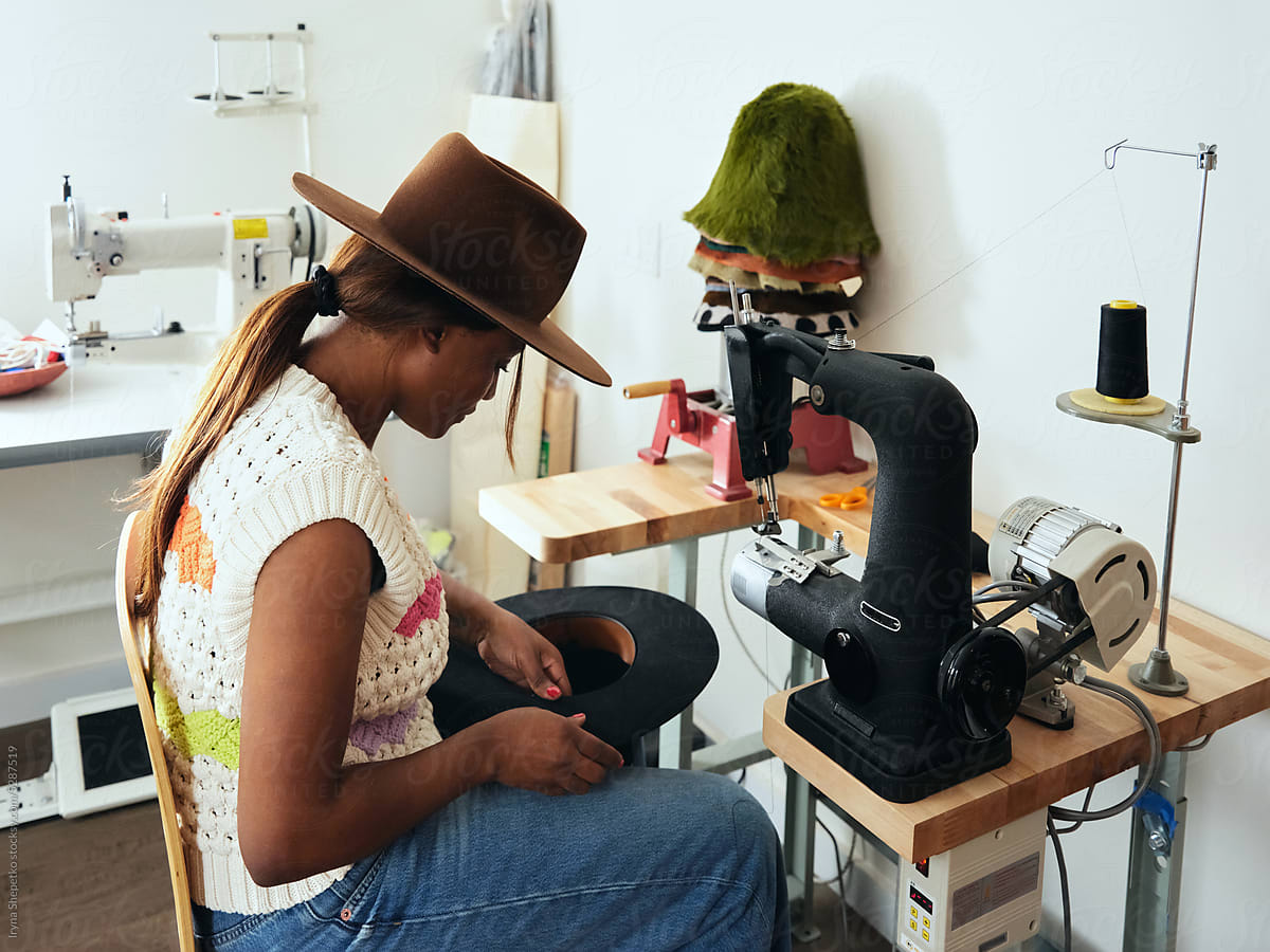 Black Woman Hat Maker In A Workshop Space, Sews On A Sewing Machine by  Stocksy Contributor Iryna Shepetko - Stocksy