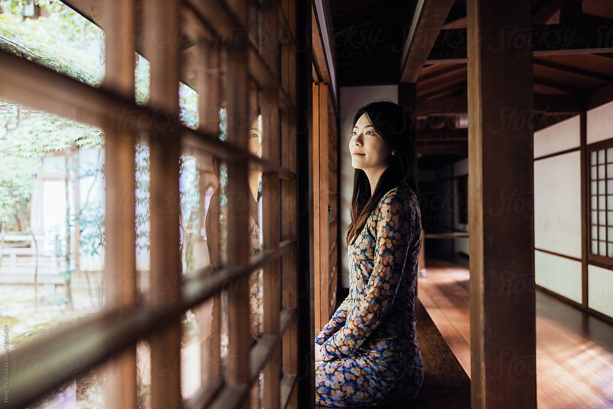 Contemplative Woman in Traditional Setting