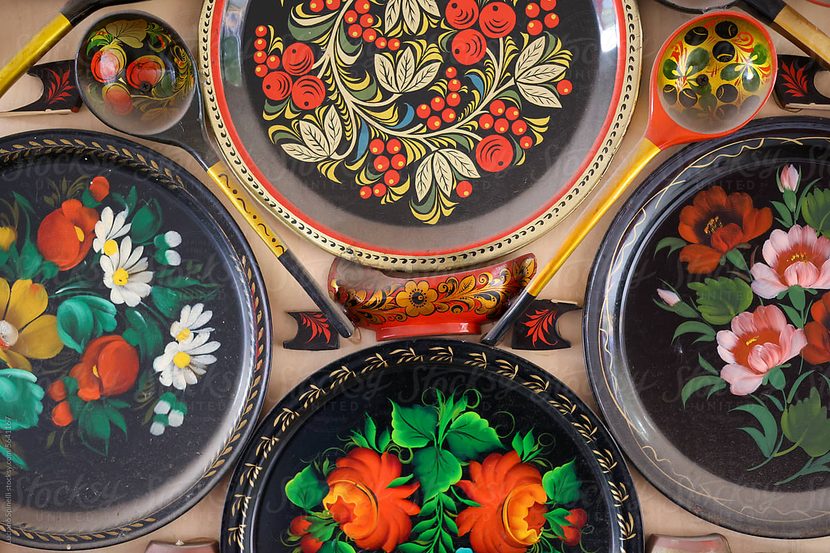 Detail of hand-decorated wooden tableware disposed over a wall