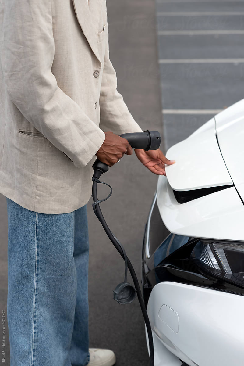 Anonymous black man charging an electric car