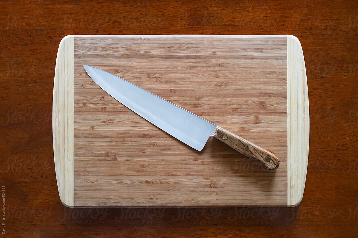 Kitchen knife on a bamboo cutting board from above