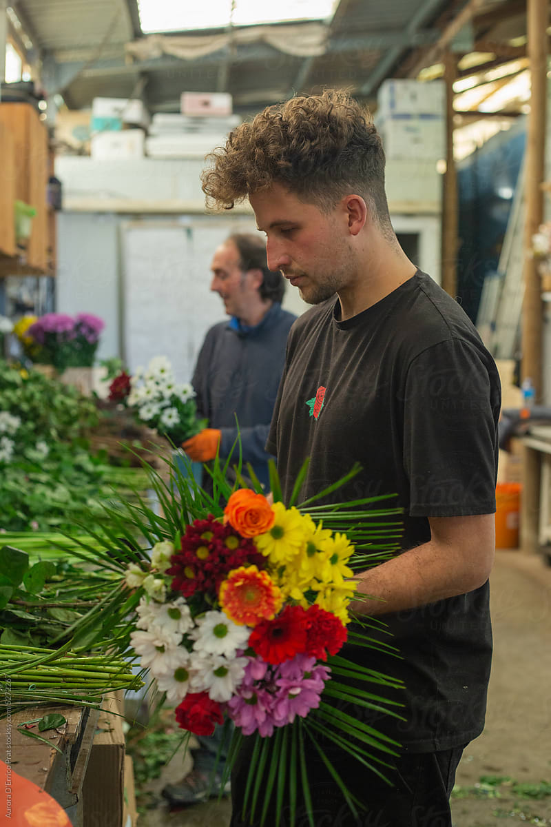 Man arranging a flower bouquet