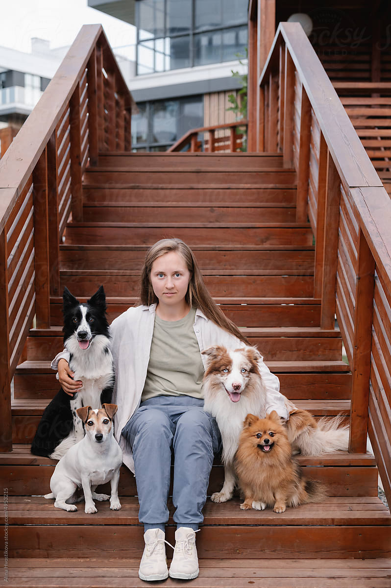 Woman with dogs sitting on steps