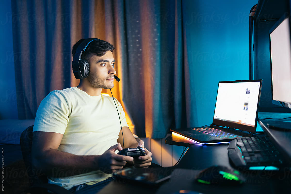 Young man playing video games on PC