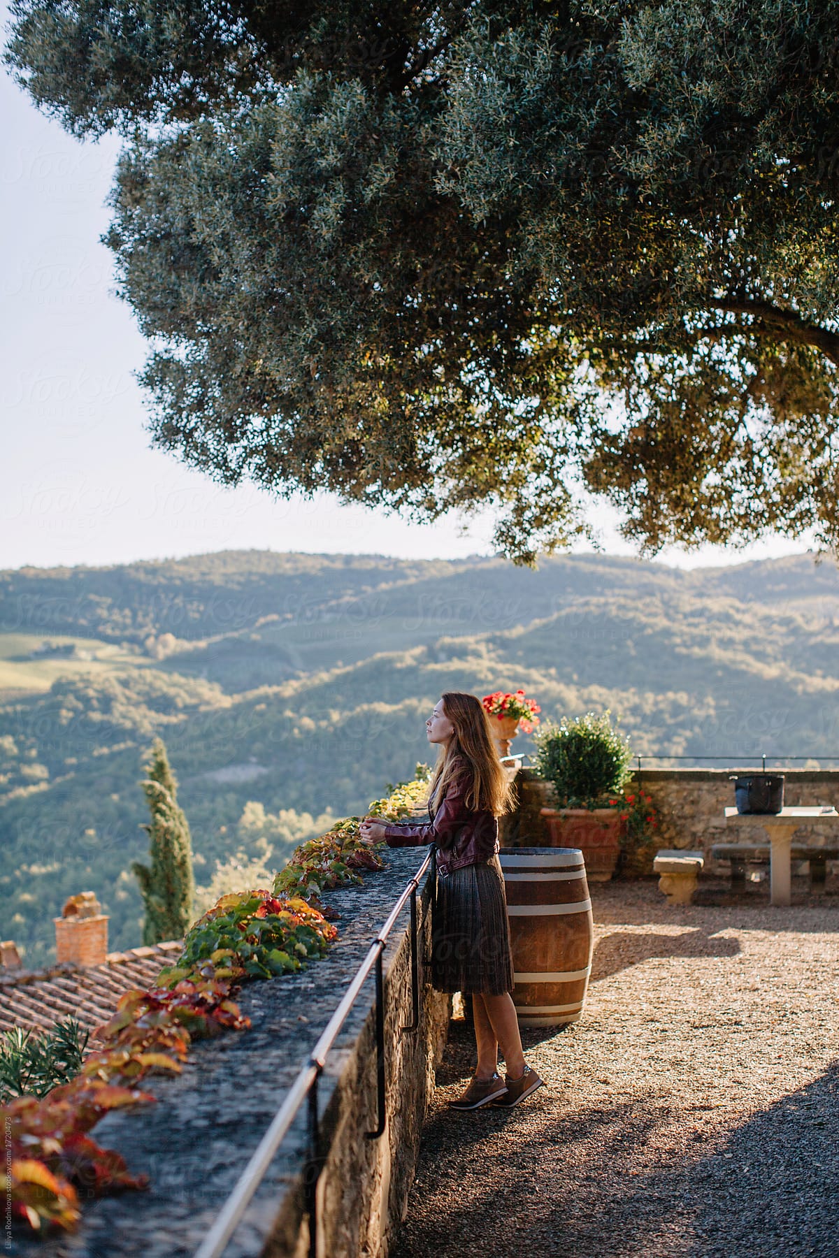 Young redhead woman enjoying the view in Tuscany Italy