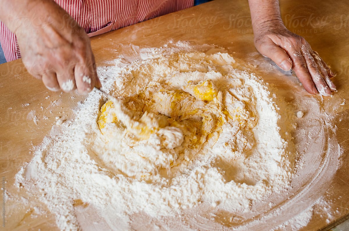 Italian woman mix flour well