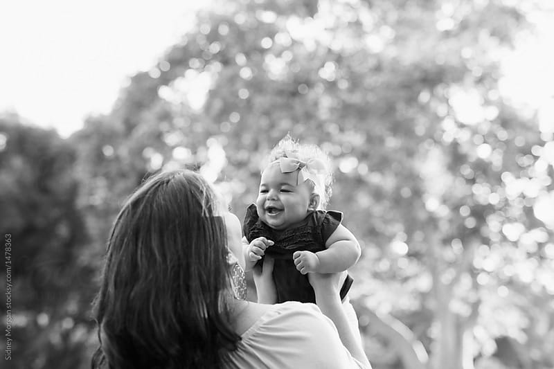 Black and White Portrait of a Mother Holding her Laughing Baby Up