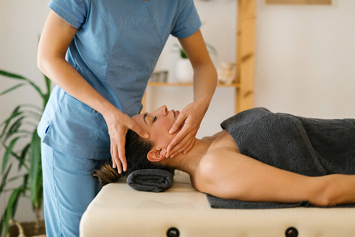 Mature woman having face massage at spa